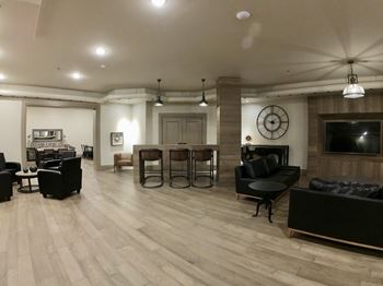 Creekside Common room living room with hardwood floors and a large clock on the wall